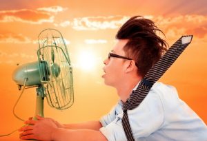 man-suffering-from-humidity-uses-electric-fan