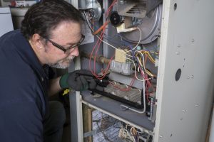 technician-overlooking-gas-furnace
